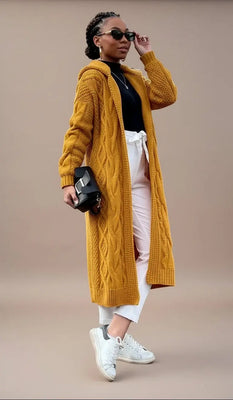 Woman wearing a mustard yellow cardigan in an outdoor setting