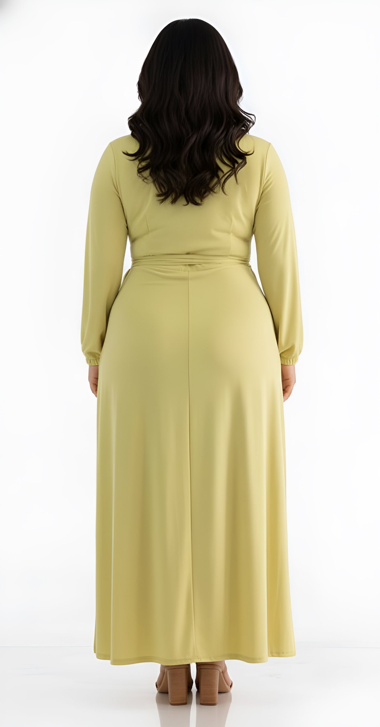 Woman wearing a long light green chartreuse dress on a white background