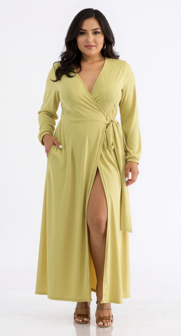 Woman wearing a chartreuse green dress with a slit on a white background