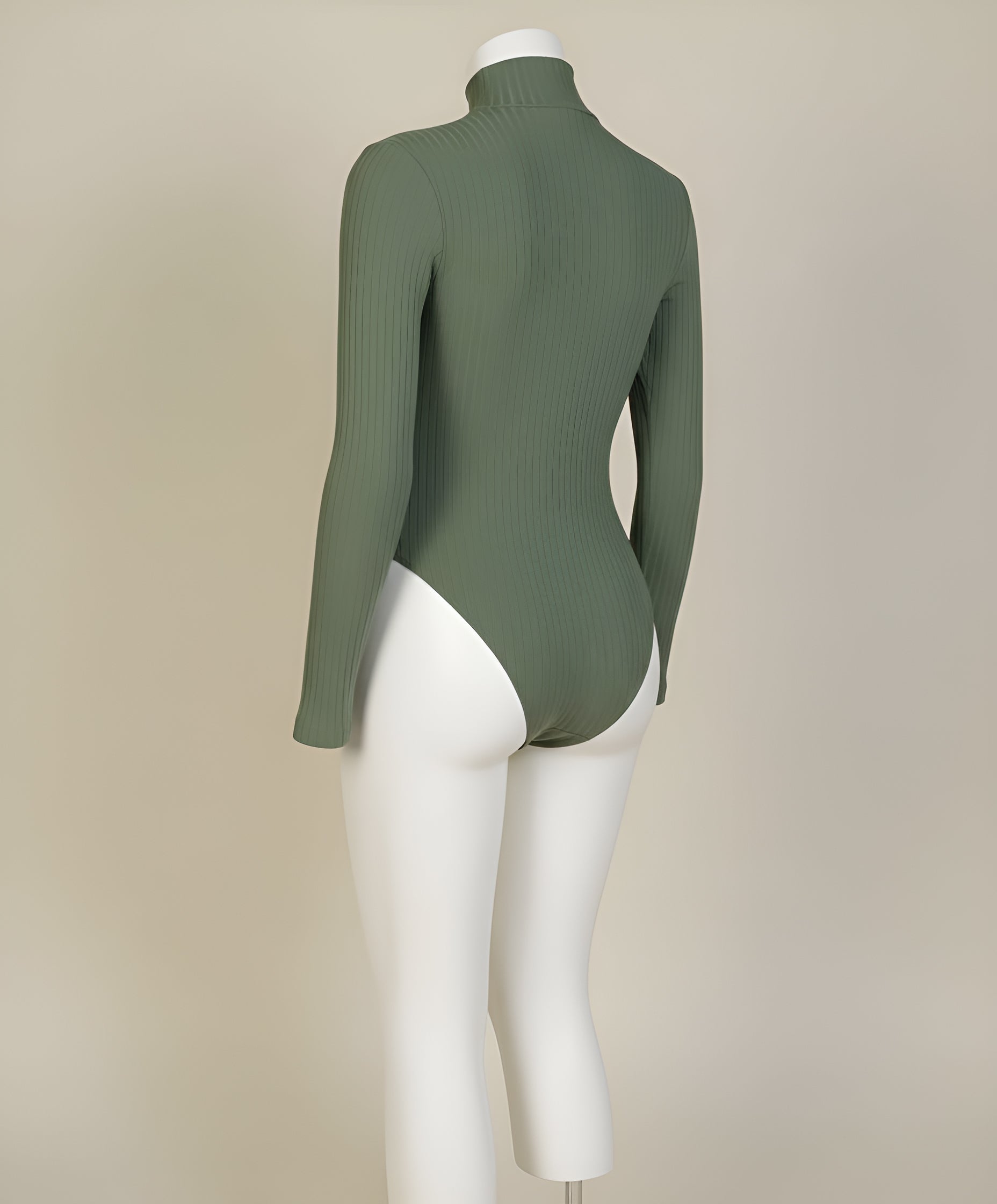 Green ribbed turtleneck sweater on a mannequin against a beige background