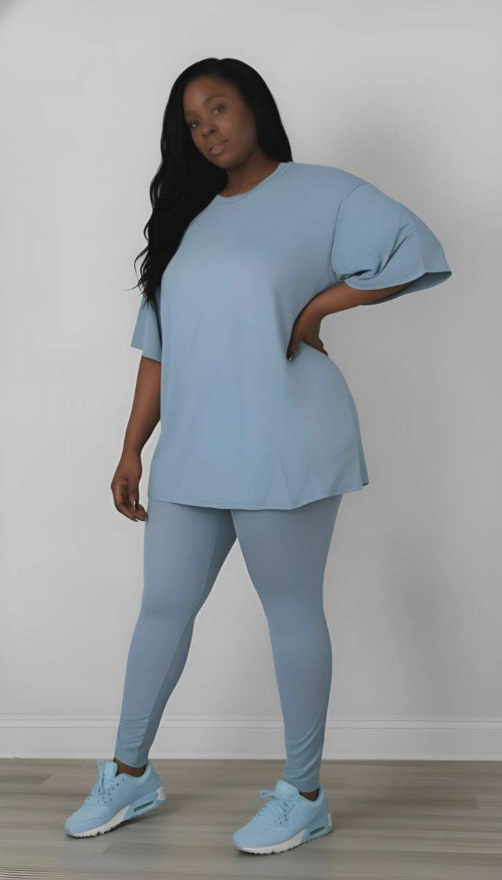 Woman wearing a light blue outfit with matching shoes against a white background